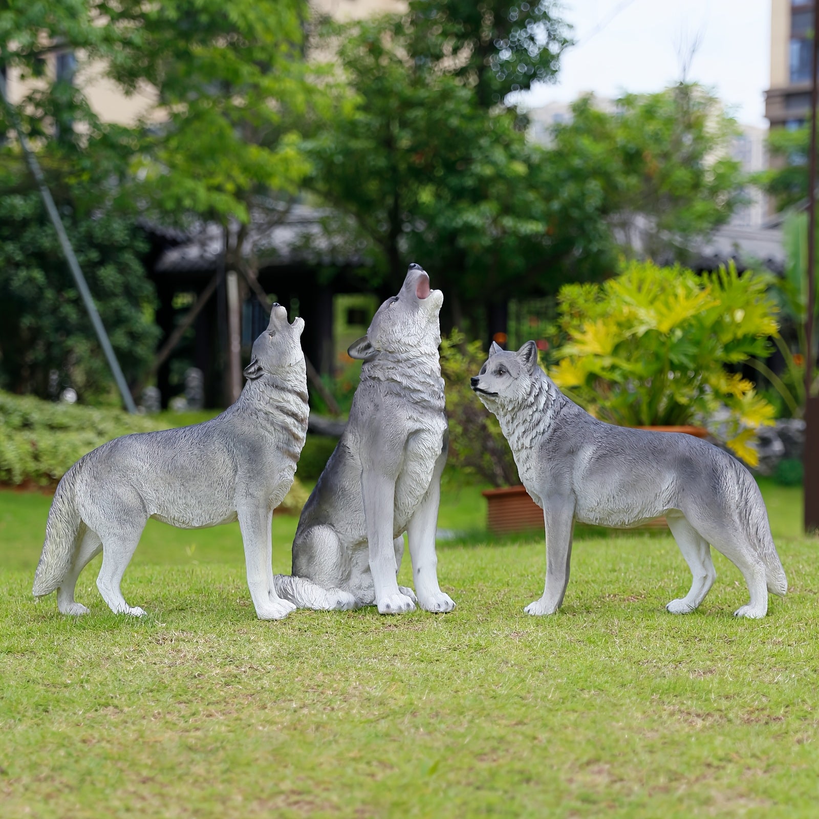 Three Realistic Howling Wolf Sculptures